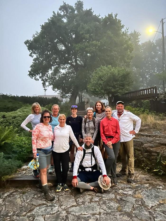 A group smiling on a misty morning on the Spanish Camino