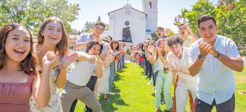 Happy students in front of the chapel